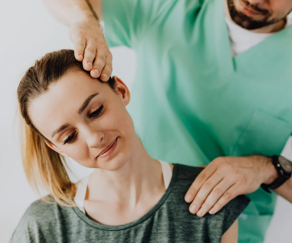 Smiling patient during a gentle neck and shoulder treatment