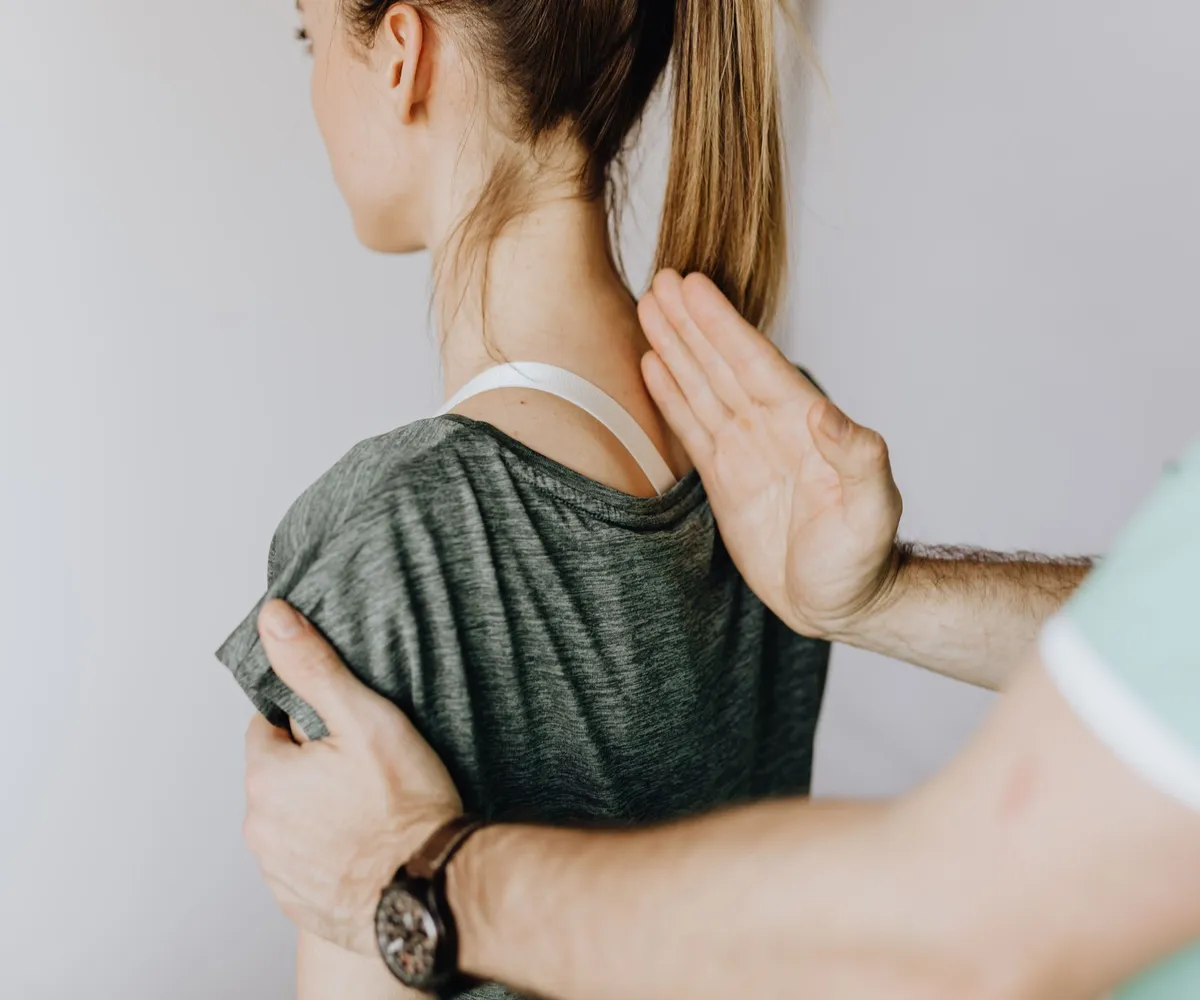Shoulder and upper back being examined during a visit