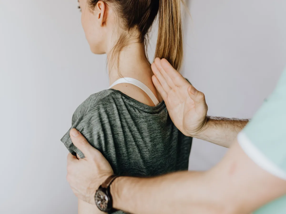 Shoulder and upper back being examined during a visit