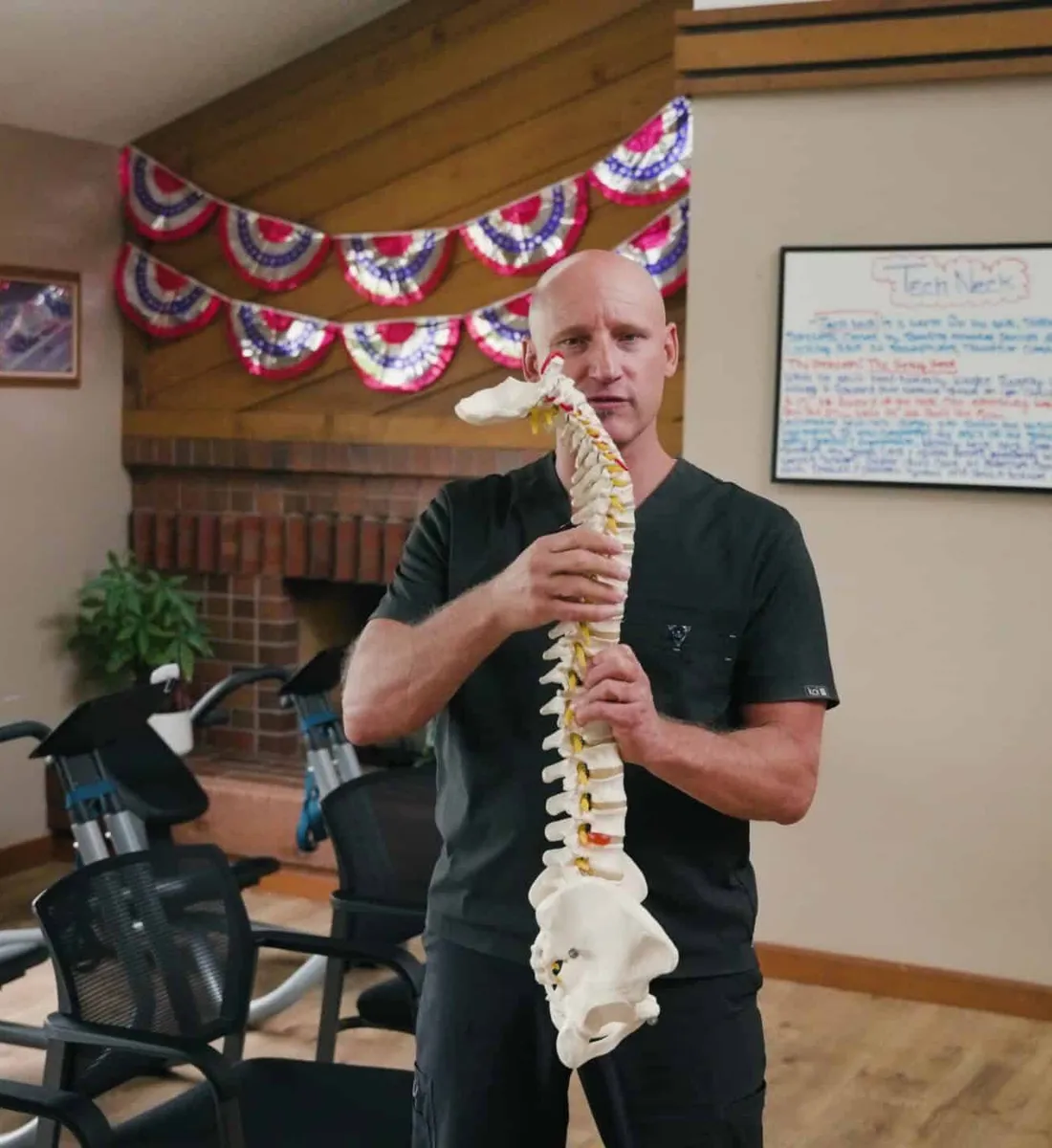 Dr. Woodbury explaining the spine with a full spine model in the rehab room