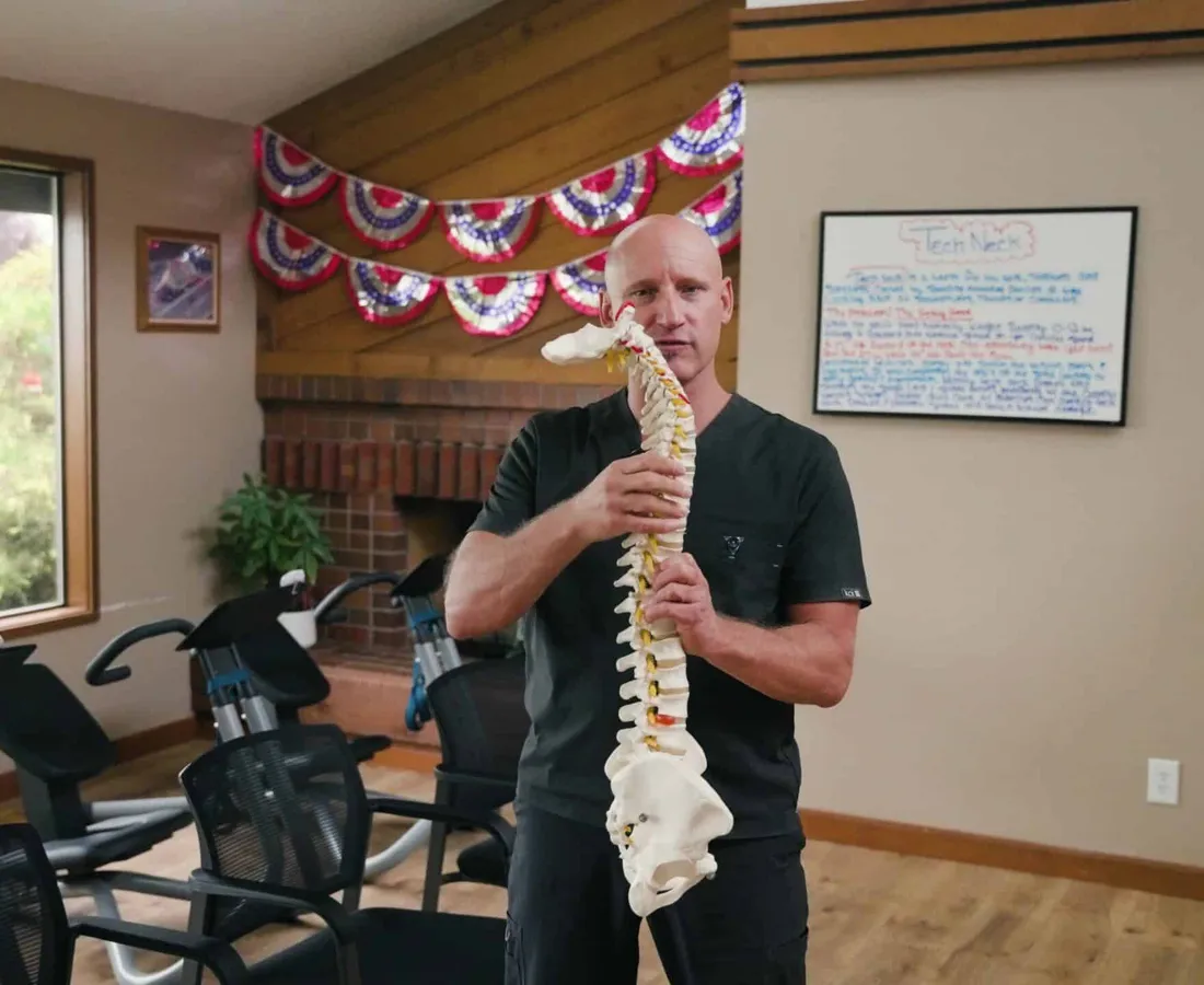 Dr. Woodbury explaining the spine with a full spine model in the rehab room