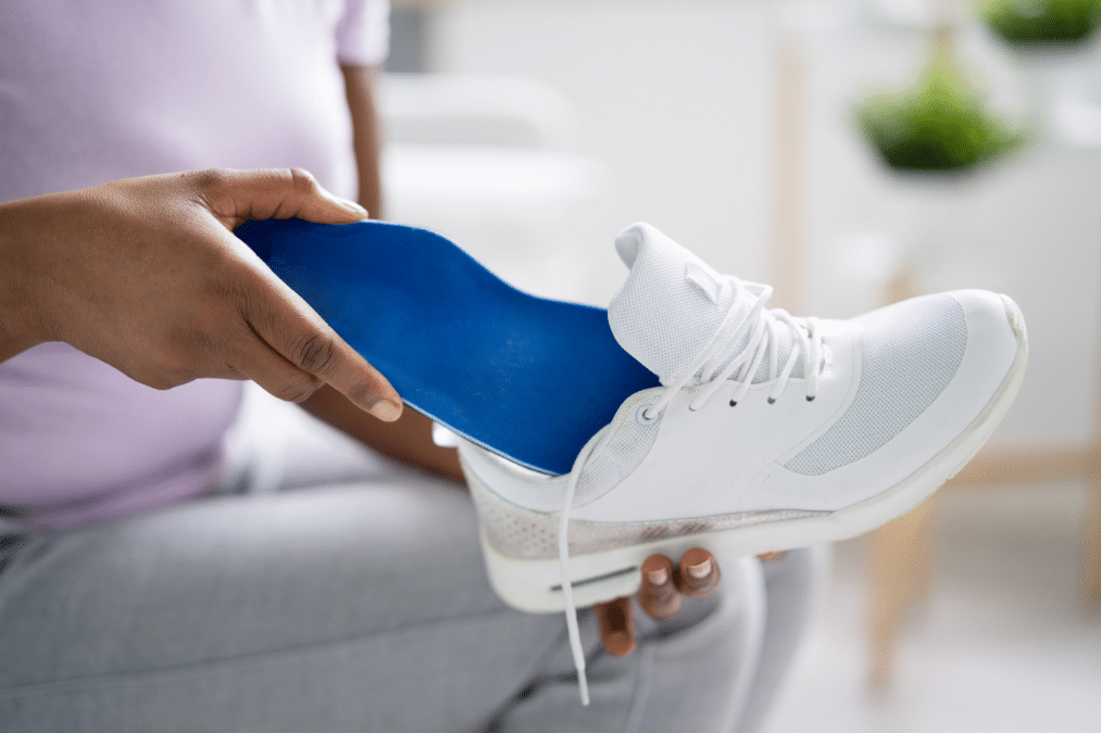Person putting custom orthotics into their shoe
