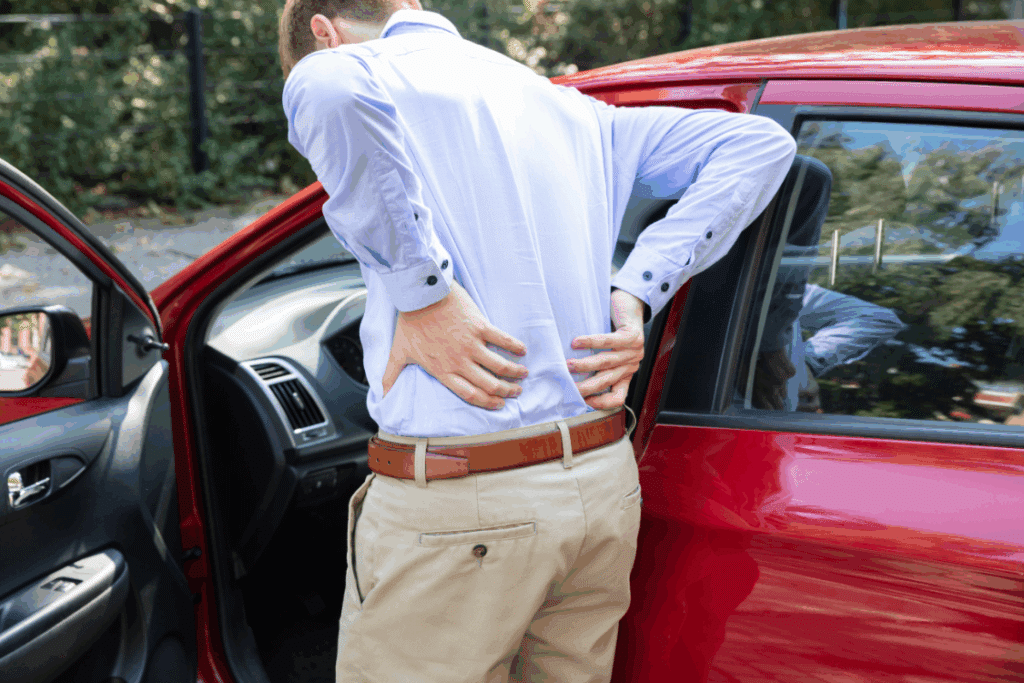 Man holding back in pain after a car accident