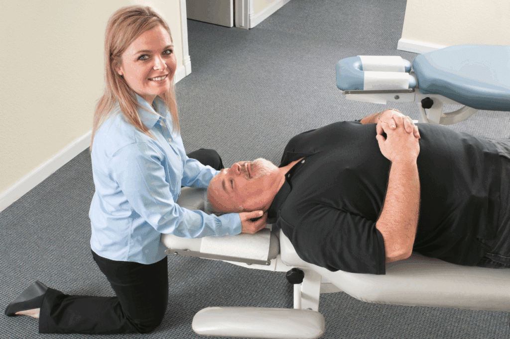 Chiropractor helping patient with neck pain